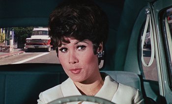 Movie still from “The Love Bug” (1969), directed by Robert Stevenson – A person sitting in a car; Close Up shot, High angle