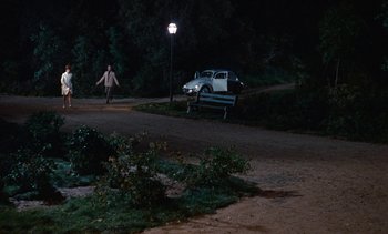 Movie still from “The Love Bug” (1969), directed by Robert Stevenson – A car parked on the side of the road at night; Extreme Wide shot, High angle