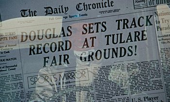 Movie still from “The Love Bug” (1969), directed by Robert Stevenson – A newspaper with a picture of a man in the middle of the front page; Extreme Close Up shot, Over the shoulder angle