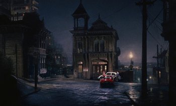 Movie still from “The Love Bug” (1969), directed by Robert Stevenson – A car parked in front of a building at night; Extreme Wide shot, High angle