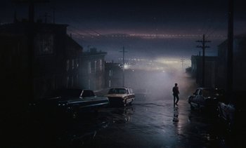 Movie still from “The Love Bug” (1969), directed by Robert Stevenson – A man walking down the street in the rain at night; Extreme Wide shot, High angle