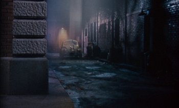 Movie still from “The Love Bug” (1969), directed by Robert Stevenson – A car parked on the side of the road at night; Wide shot, High angle