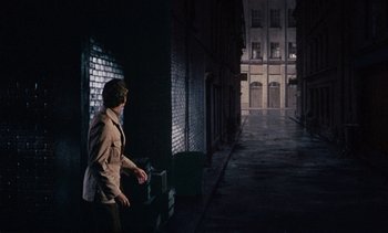 Movie still from “The Love Bug” (1969), directed by Robert Stevenson – A man walking down a dark alley way; Wide shot, High angle