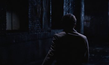 Movie still from “The Love Bug” (1969), directed by Robert Stevenson – A man wearing a suit walking in the dark; Wide shot, Over the shoulder angle