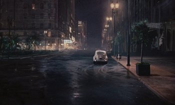 Movie still from “The Love Bug” (1969), directed by Robert Stevenson – A car driving down a street at night; Extreme Wide shot, High angle