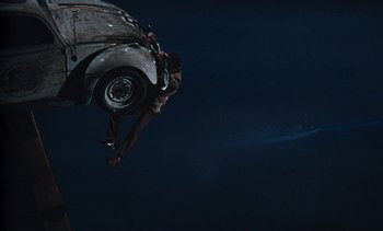 Movie still from “The Love Bug” (1969), directed by Robert Stevenson – A man flying through the air while riding a skateboard; Extreme Wide shot, Overhead angle