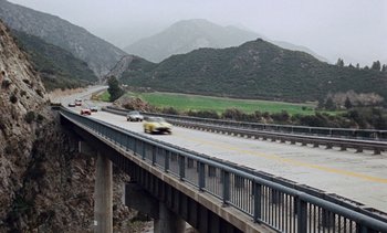 Movie still from “The Love Bug” (1969), directed by Robert Stevenson – Cars driving on a bridge over a river; Extreme Wide shot, High angle