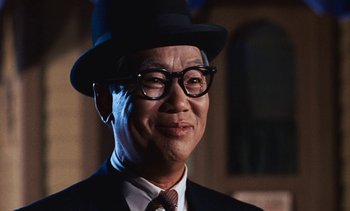 Movie still from “The Love Bug” (1969), directed by Robert Stevenson – An older man wearing a hat and glasses; Close Up shot, Low angle
