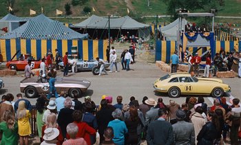 Movie still from “The Love Bug” (1969), directed by Robert Stevenson – A crowd of people watching two cars on a race track; Extreme Wide shot, High angle