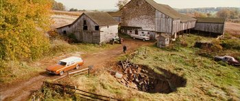Movie still from “The Lovely Bones” (2009), directed by Peter Jackson – An old barn with a man walking down the road; Extreme Wide shot, High angle