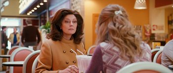 Movie still from “The Lovely Bones” (2009), directed by Peter Jackson – A woman in a brown coat talking to another woman in a yellow dress; Close Up shot, Over the shoulder angle
