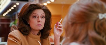 Movie still from “The Lovely Bones” (2009), directed by Peter Jackson – A woman looking in the mirror while holding a cigarette; Close Up shot, Over the shoulder angle