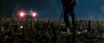 Movie still from “The Lovely Bones” (2009), directed by Peter Jackson – A person standing in the middle of a field at night; Wide shot, Low angle