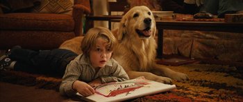 Movie still from “The Lovely Bones” (2009), directed by Peter Jackson – A boy and a dog laying next to each other on the floor; Medium shot, High angle