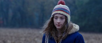 Movie still from “The Lovely Bones” (2009), directed by Peter Jackson – A young girl wearing a colorful knitted hat; Close Up shot, Over the shoulder angle
