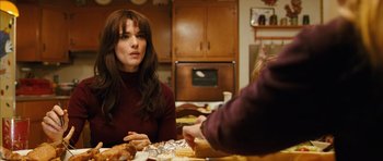 Movie still from “The Lovely Bones” (2009), directed by Peter Jackson – A woman sitting at a table with food on it; Medium shot, Over the shoulder angle