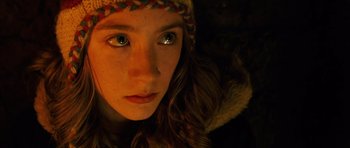 Movie still from “The Lovely Bones” (2009), directed by Peter Jackson – A person wearing a hat and looking at the camera; Close Up shot, Overhead angle