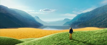 Movie still from “The Lovely Bones” (2009), directed by Peter Jackson – A person standing on top of a grass covered hill; Extreme Wide shot, High angle