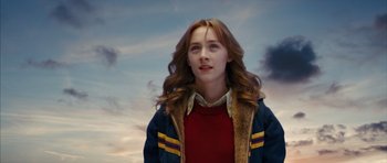 Movie still from “The Lovely Bones” (2009), directed by Peter Jackson – A woman with long red hair wearing a red shirt and a blue jacket; Medium shot, Low angle