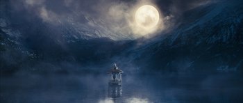 Movie still from “The Lovely Bones” (2009), directed by Peter Jackson – A person on a boat in a body of water with a full moon in the background; Extreme Wide shot, Low angle