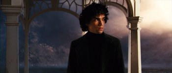 Movie still from “The Lovely Bones” (2009), directed by Peter Jackson – A man in a black jacket standing in front of an archway; Close Up shot, Low angle