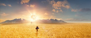 Movie still from “The Lovely Bones” (2009), directed by Peter Jackson – A person riding a motorcycle through a field of wheat; Extreme Wide shot, High angle