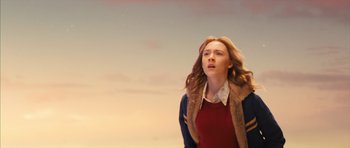 Movie still from “The Lovely Bones” (2009), directed by Peter Jackson – A woman standing in front of the sky looking up at the sky; Medium shot, Low angle