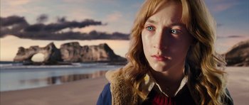 Movie still from “The Lovely Bones” (2009), directed by Peter Jackson – A person on a beach; Close Up shot, High angle