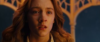 Movie still from “The Lovely Bones” (2009), directed by Peter Jackson – A young girl's face in a dark room; Close Up shot, High angle