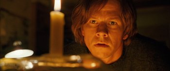 Movie still from “The Lovely Bones” (2009), directed by Peter Jackson – A person looking at a candle; Close Up shot, Low angle
