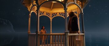 Movie still from “The Lovely Bones” (2009), directed by Peter Jackson – Two people standing in a gazebo at night; Wide shot, Low angle