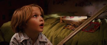 Movie still from “The Lovely Bones” (2009), directed by Peter Jackson – A little boy sitting on top of a bed looking up; Close Up shot, High angle