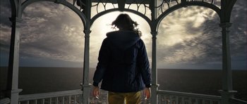 Movie still from “The Lovely Bones” (2009), directed by Peter Jackson – A woman standing in a gazebo looking out at the ocean; Wide shot, Low angle