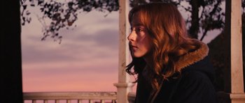 Movie still from “The Lovely Bones” (2009), directed by Peter Jackson – A woman with long red hair is standing on a porch; Close Up shot, Over the shoulder angle