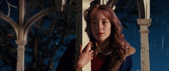 Movie still from “The Lovely Bones” (2009), directed by Peter Jackson – A young woman leaning against a wooden post; Close Up shot, High angle