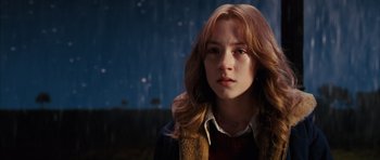 Movie still from “The Lovely Bones” (2009), directed by Peter Jackson – A woman with long hair is standing in the rain; Close Up shot, High angle