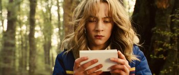 Movie still from “The Lovely Bones” (2009), directed by Peter Jackson – A woman holding a book in her hands; Close Up shot, Low angle