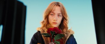 Movie still from “The Lovely Bones” (2009), directed by Peter Jackson – A woman holding a rose in front of her face; Close Up shot, High angle