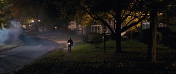 Movie still from “The Lovely Bones” (2009), directed by Peter Jackson – A person walking down a sidewalk at night; Extreme Wide shot, High angle