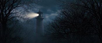 Movie still from “The Lovely Bones” (2009), directed by Peter Jackson – A light shining on a lighthouse in the dark; Extreme Wide shot, Low angle
