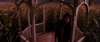 Movie still from “The Lovely Bones” (2009), directed by Peter Jackson – A woman standing on a porch in front of a gazebo; Wide shot, High angle