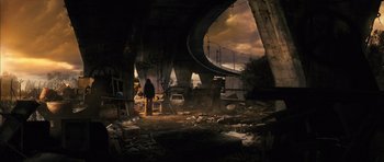 Movie still from “The Lovely Bones” (2009), directed by Peter Jackson – A person standing in a destroyed area next to a bridge; Wide shot, Low angle