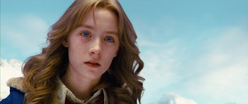 Movie still from “The Lovely Bones” (2009), directed by Peter Jackson – A person with long hair and blue eyes; Close Up shot, Low angle