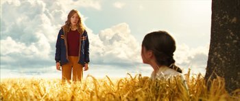 Movie still from “The Lovely Bones” (2009), directed by Peter Jackson – Two young girls are standing in a field of hay; Medium shot, Low angle