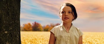 Movie still from “The Lovely Bones” (2009), directed by Peter Jackson – A young girl standing in front of a field of wheat; Close Up shot, High angle