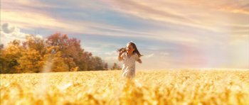 Movie still from “The Lovely Bones” (2009), directed by Peter Jackson – A young girl running through a field of yellow flowers; Extreme Wide shot, Low angle
