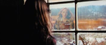 Movie still from “The Lovely Bones” (2009), directed by Peter Jackson – A woman looking out of a window at herself; Medium shot, Over the shoulder angle