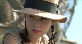 Movie still from “The Lover” (1992), directed by Jean-Jacques Annaud – A young girl wearing a hat with a bow in her hair; Close Up shot, Low angle