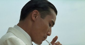 Movie still from “The Lover” (1992), directed by Jean-Jacques Annaud – A person brushing his teeth; Close Up shot, Low angle