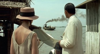 Movie still from “The Lover” (1992), directed by Jean-Jacques Annaud – A man and a woman look out over the water; Medium shot, Over the shoulder angle